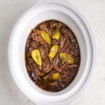 Overhead photo of pot roast with pepperoncini peppers, ready to serve.