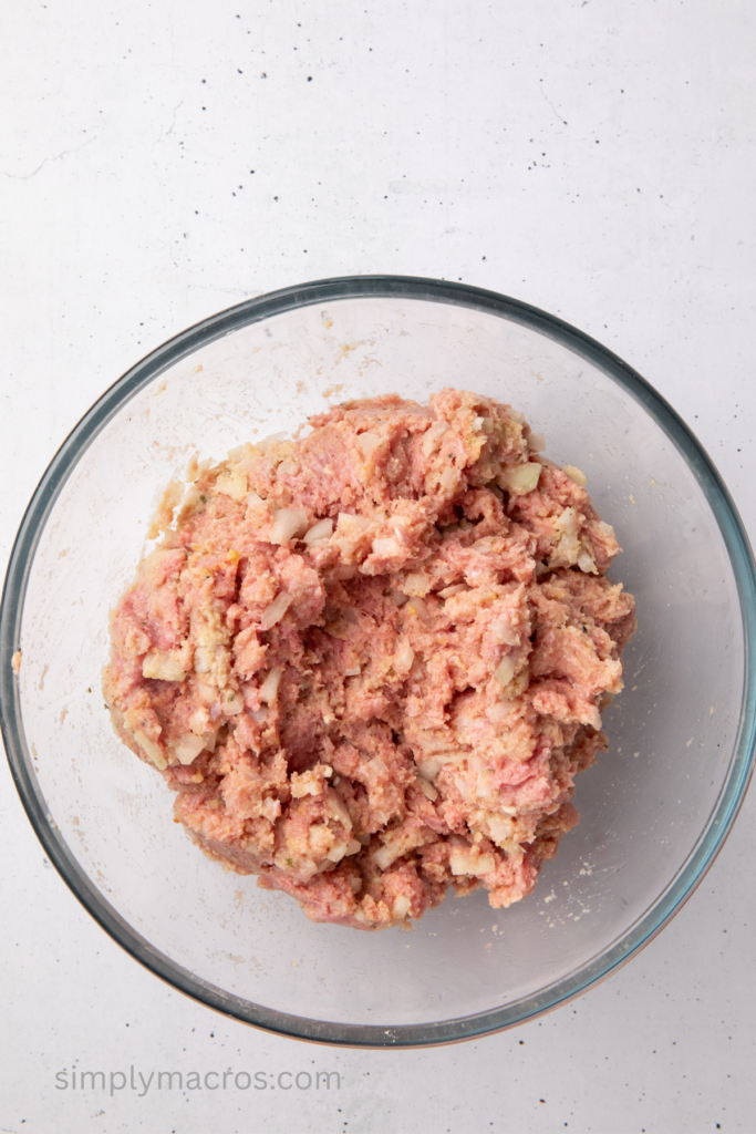 Turkey and other ingredients combined in a bowl that are used to make the loaf.