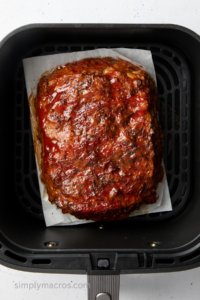 Turkey meatloaf in the basket of the air fryer ready to serve.