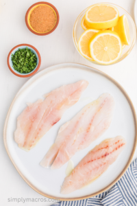 grouper filets on a plate brushed with oil.