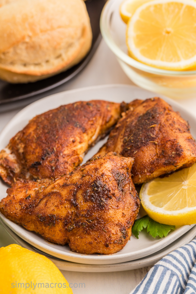 Fully cooked blackened grouper filets on a plate, ready to eat.