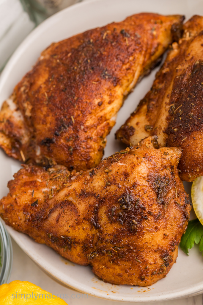 Close up of blackened grouper filets on a plate, ready to eat.