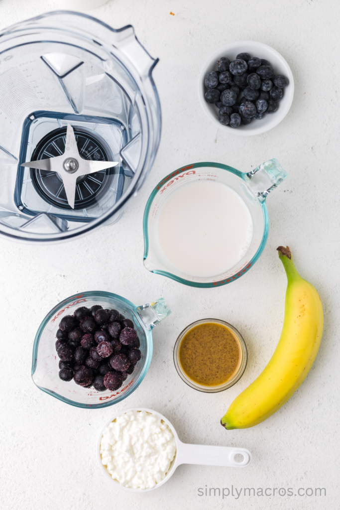 Ingredients needed to make a blueberry banana smoothie in the blender. 