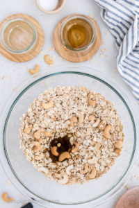 coconut oil, agave, and vanilla added to the mixing bowl with the oat mixture.