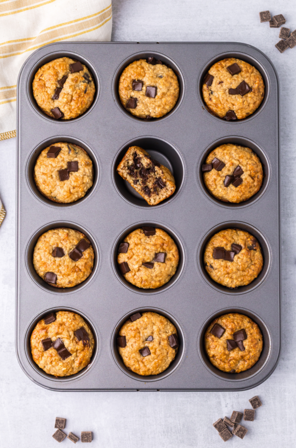 Cottage cheese muffins with chocolate chunks in a muffin tin.