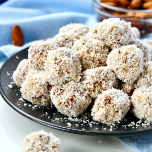 Healthy raw coconut almond bites on a plate and ready to serve.