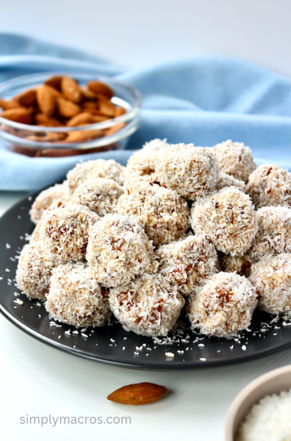 Raw coconut almond bites are on a plate and ready to eat.