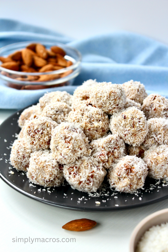 Plate full of healthy raw coconut almond bites.