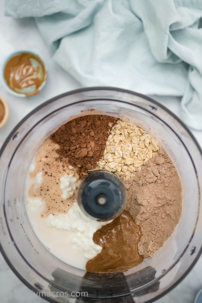 Ingredients for cottage cheese chocolate mousse in a food processor ready to blend.