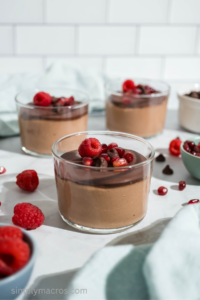 Cottage cheese chocolate mousse topped with chocolate chips, raspberries, and pomegranate seeds.