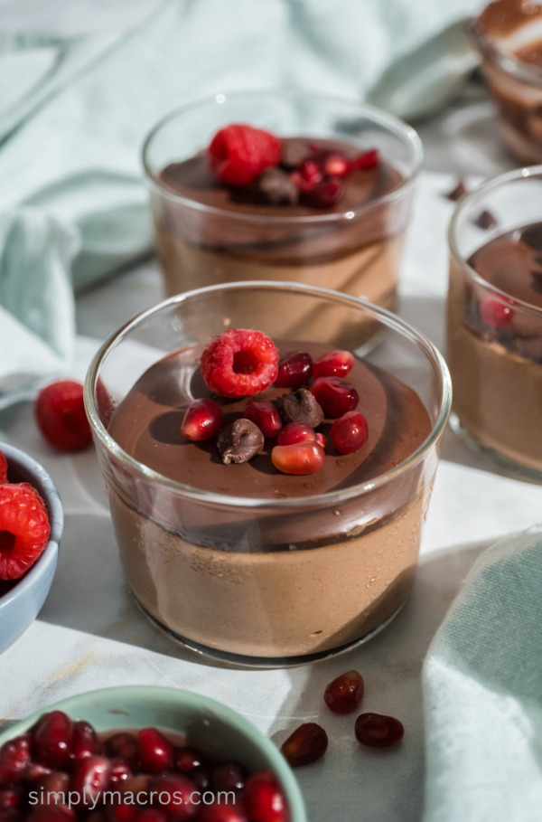 Cottage cheese chocolate mousse in glass containers topped with fruit, ready to eat.