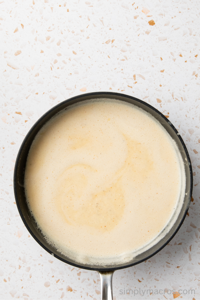 Cheese sauce thickened in a saucepan. 