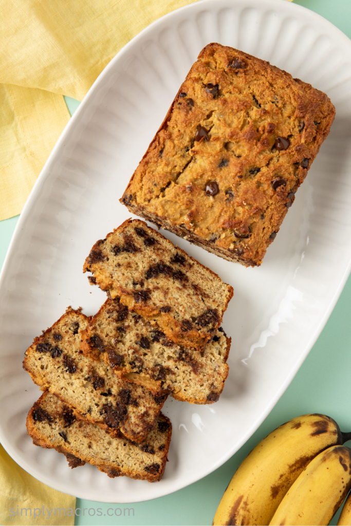 Chocolate chip protein banana bread sliced and on a serving plate.