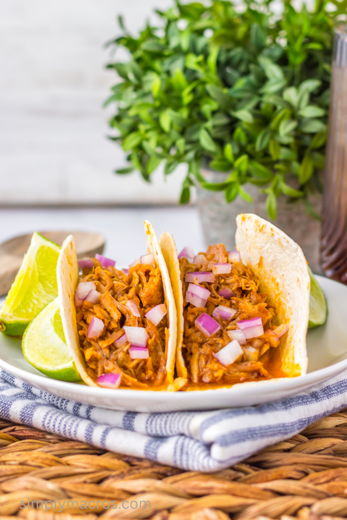 Sweet enchilada pork in tortillas and topped with fresh diced onions.