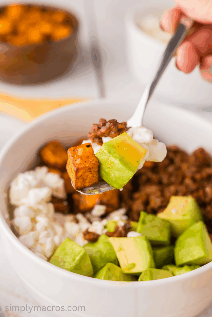 Hot honey sweet potato ground beef bowl with a fork holding a bite. 