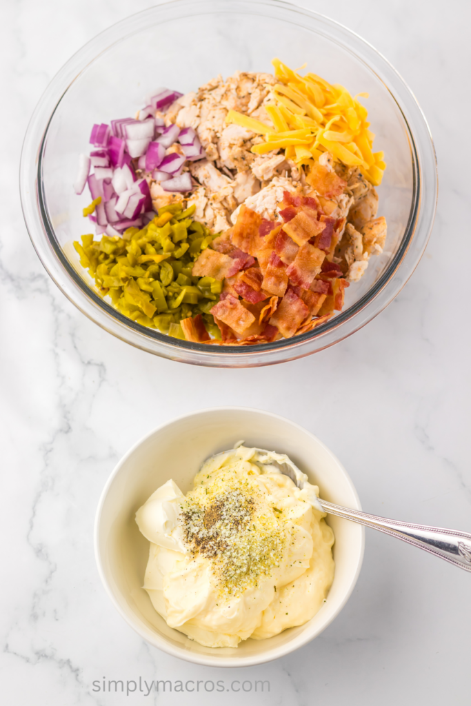 Bowls combined with the ingredients to make jalapeno popper chicken salad.