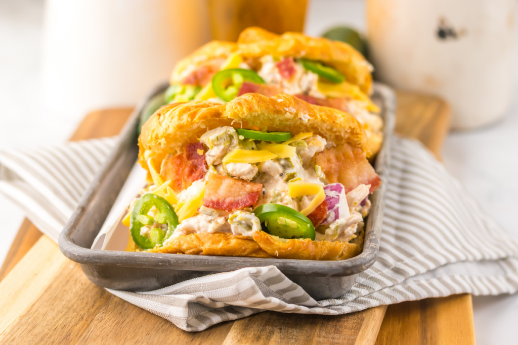 Jalapeno popper chicken salad on croissants ready to eat. 