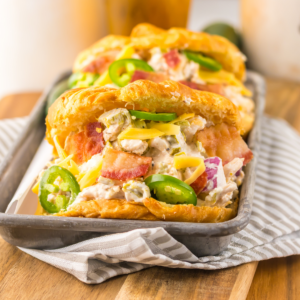 Twp jalapeno popper chicken salad sandwiches on a tray ready to eat.