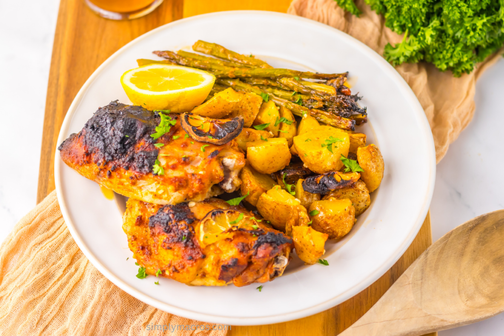 Lemon garlic chicken with vegetables on a plate and ready to eat.