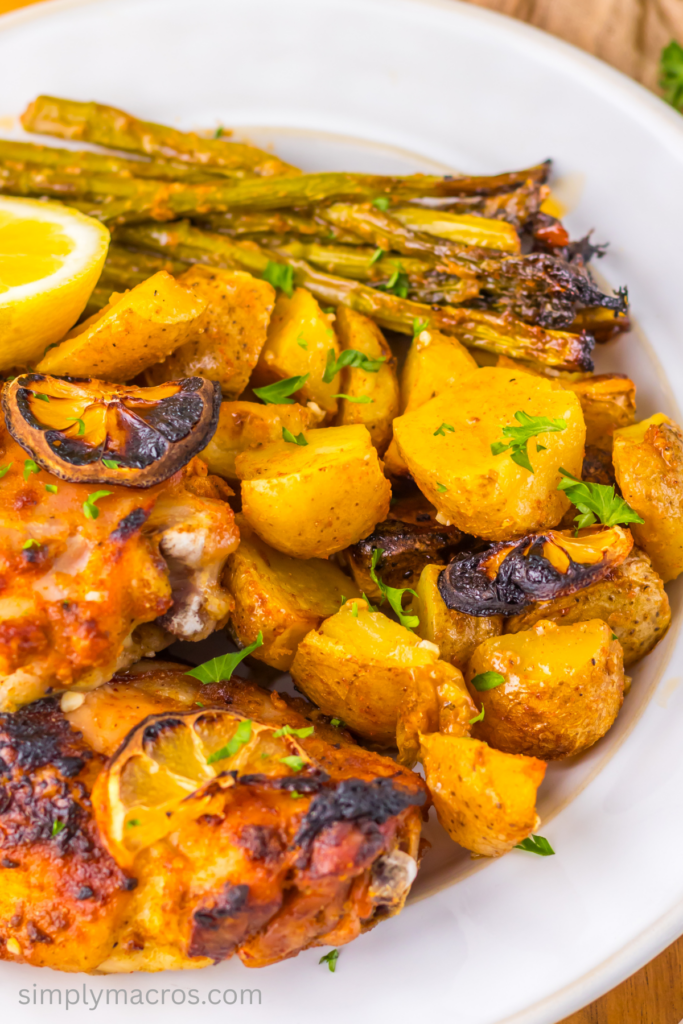 Plate of lemon garlic chicken with potatoes and asparagus.