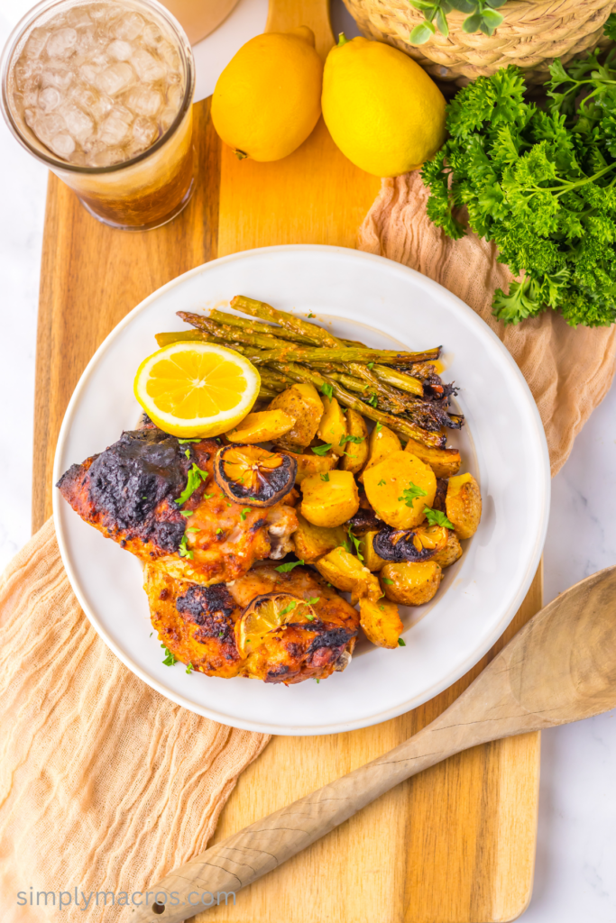 Overhead photo of leamon garlic chicken with potatoes and asparagus on a plate and ready to serve.