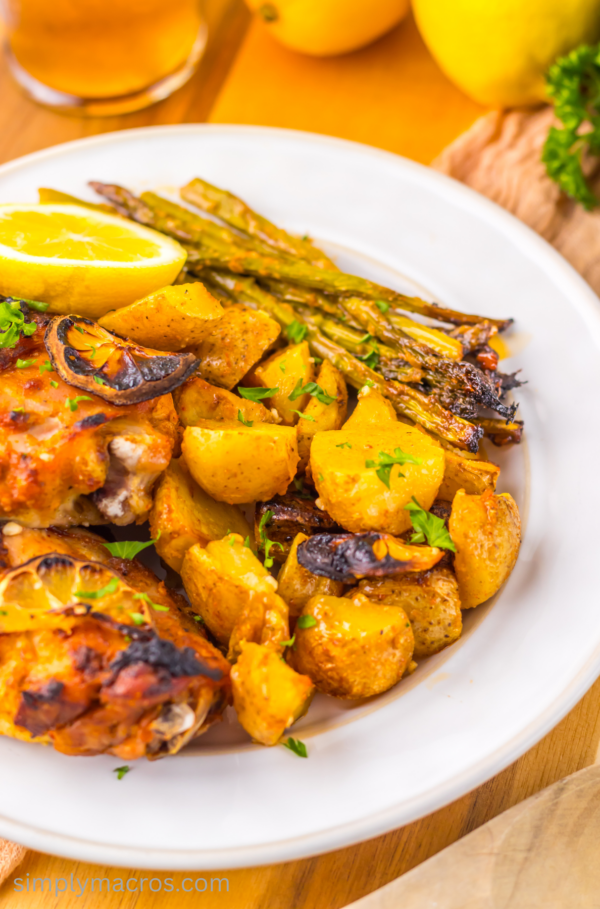 Plate of lemon garlic chicken with potatoes and asparagus.