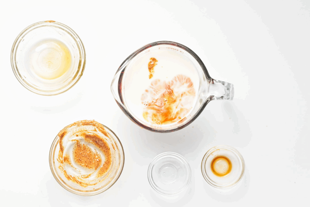 Almond milk, butter, syrup, vanilla, and saly added into a cup to blend.