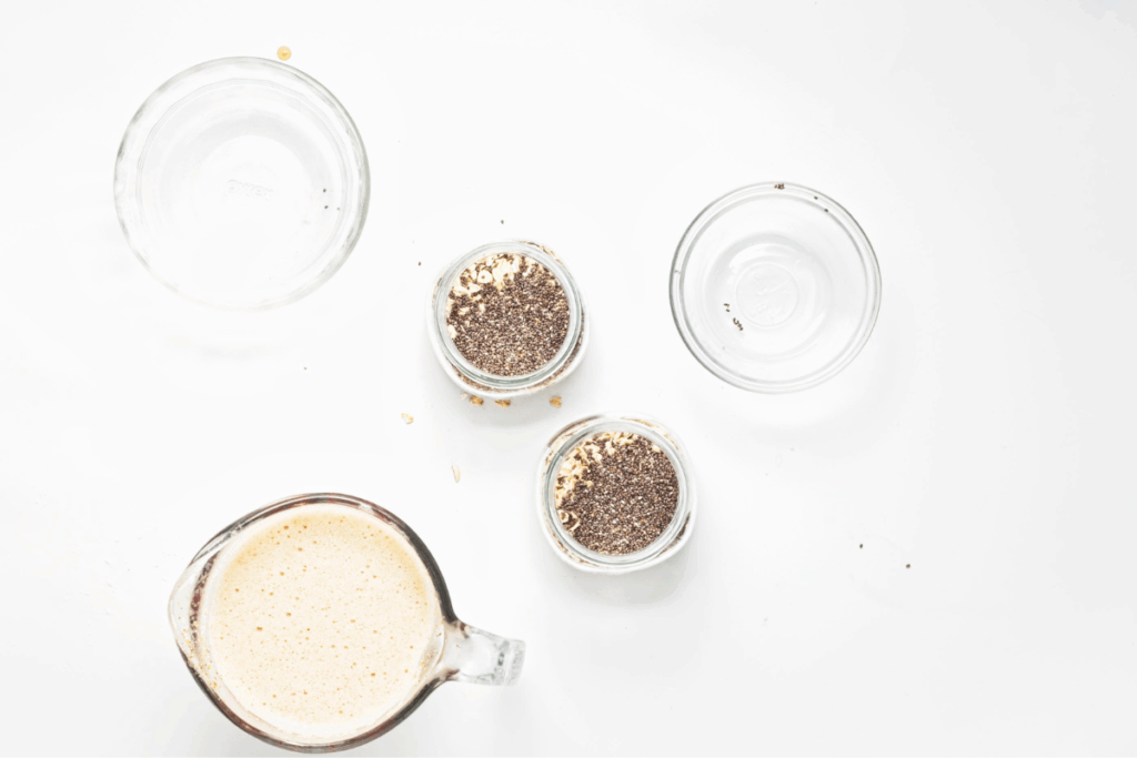 Rolled oats and chia seeds added to the containers. 