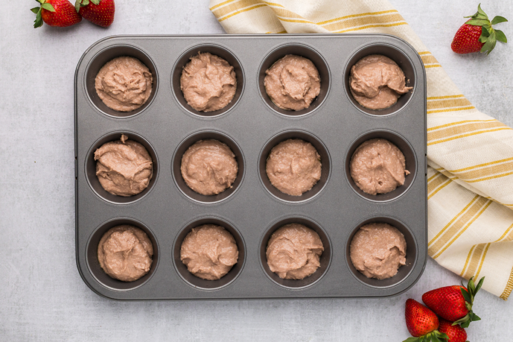 Batter scooped into the muffin tin. 