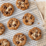 Almond butter chocolate chip cookies on a cooling rack, ready to eat.