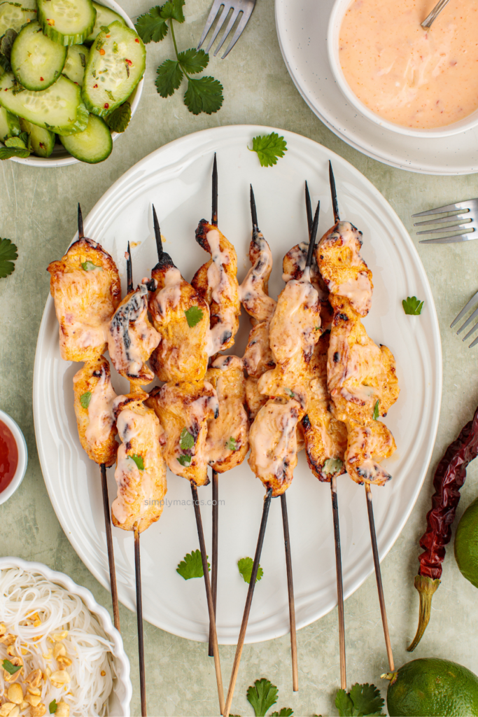 Plate of bang bang chicken skewers ready to serve.