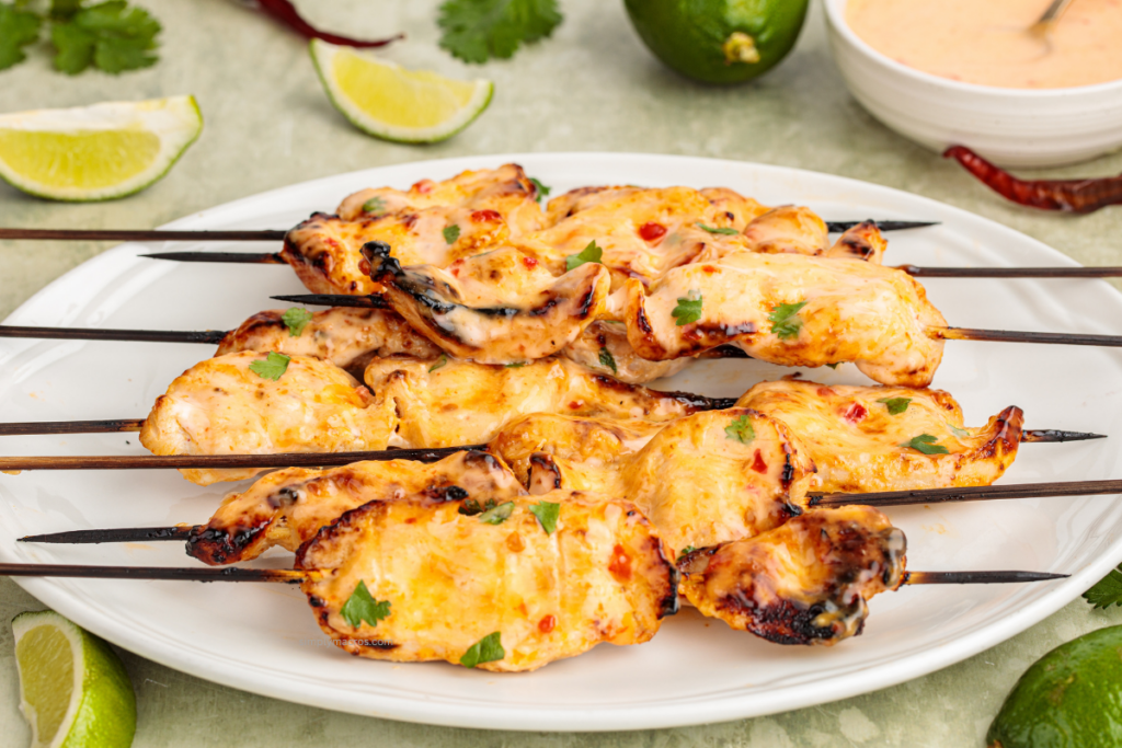 Bang bang chicken skewers on a plate ready to serve.