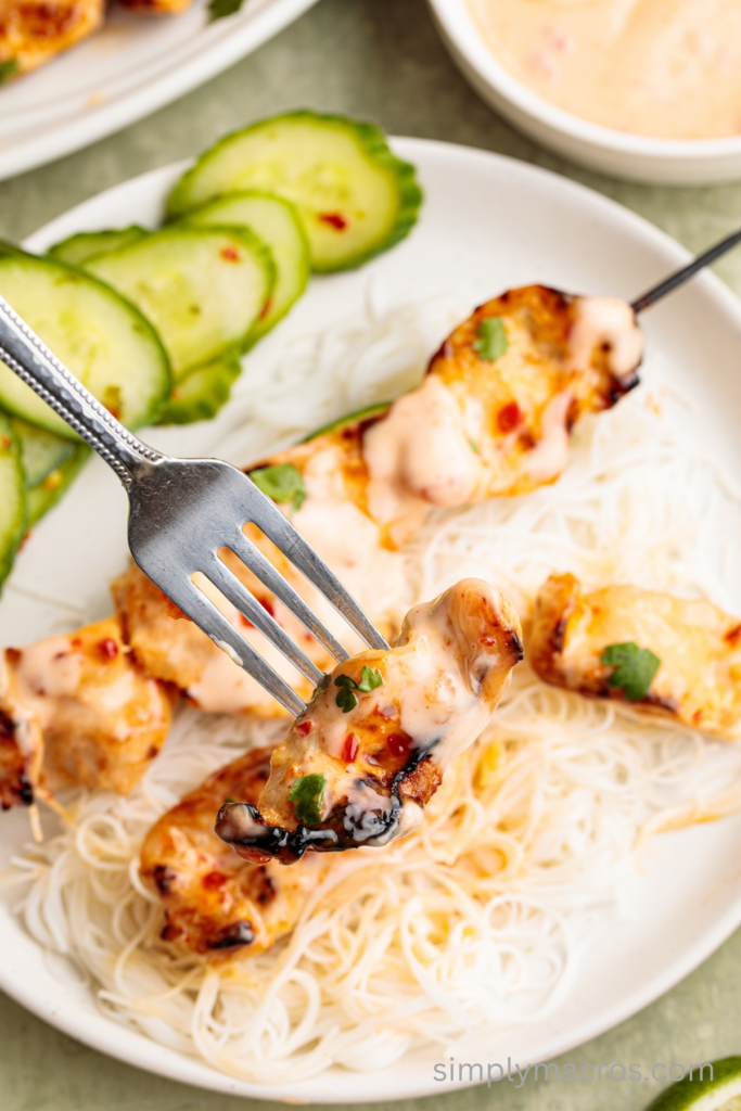 Bite of a piece of bang bang chicken on a fork.