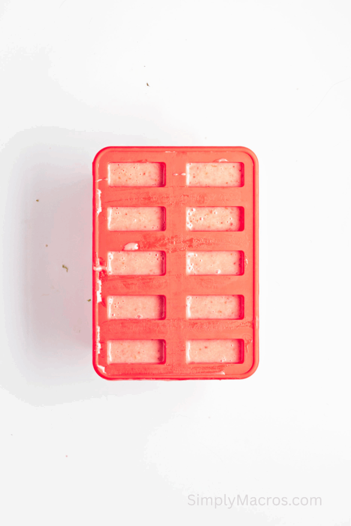 Strawberry lime and coconut mixture placed into molds.