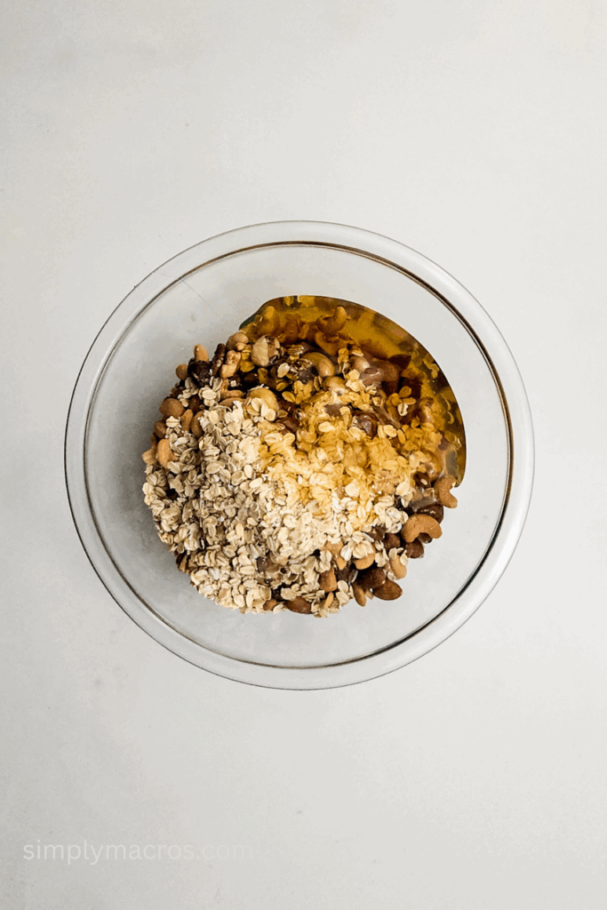 Ingredients to make homemade granola nut bars combined in a bowl.