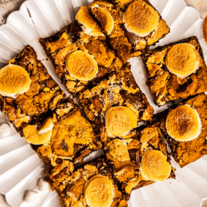 Pumpkin S'mores bars on a white plate ready to serve.