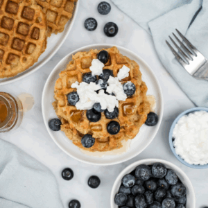 Cottage cheese waffles topped with a little cottage cheese, blueberries, and ready to serve.