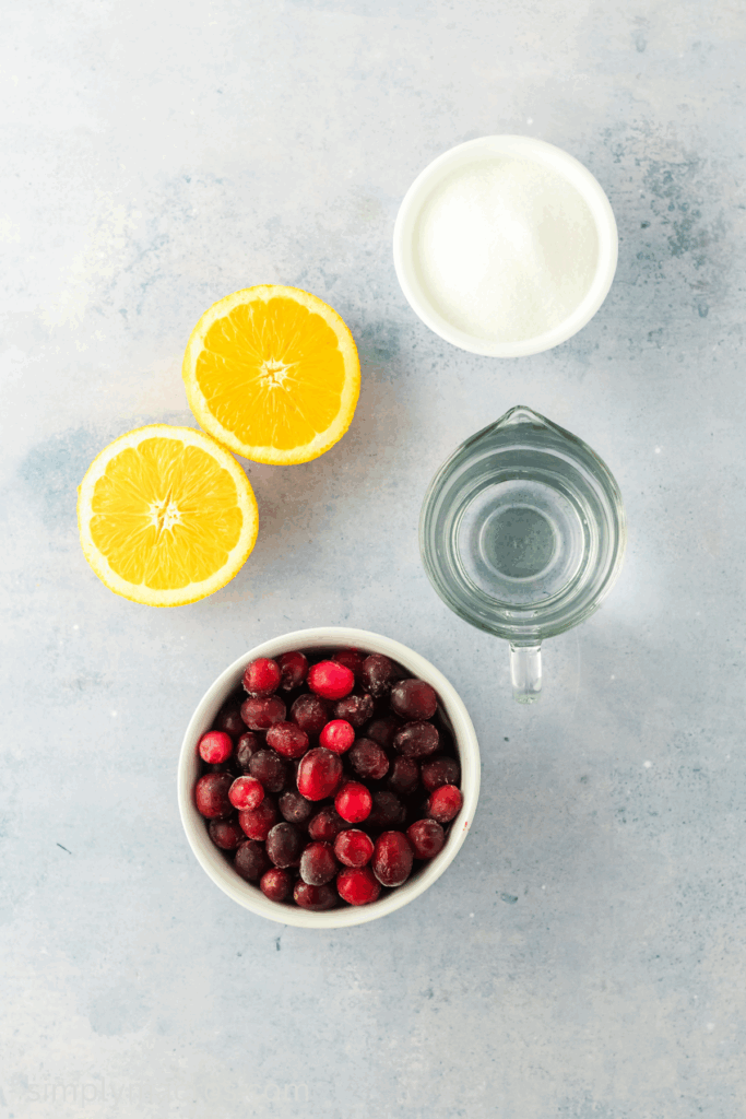 Cranberries, water, sugar, and orange, measured out to make cranberry sauce.