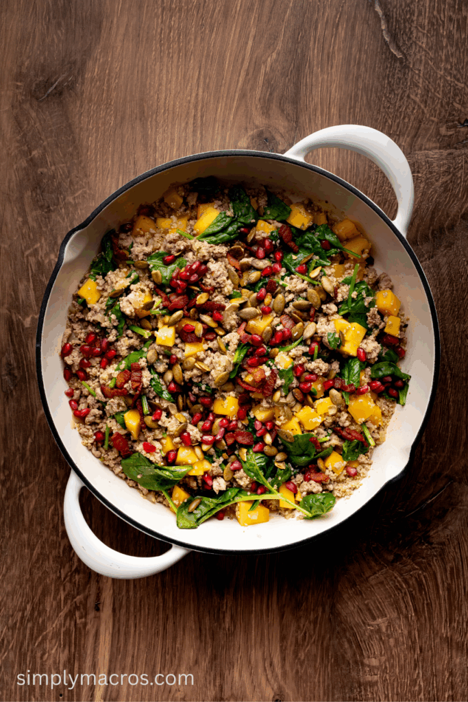 Turkey quinoa skillet with butternut squash topped with pumpkin seeds and pomegranate.